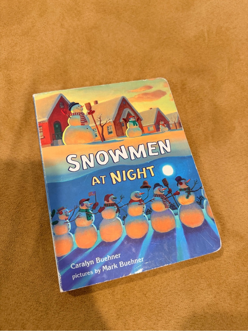 children's picture board book "Snowmen at Night" written by Caralyn Buehner